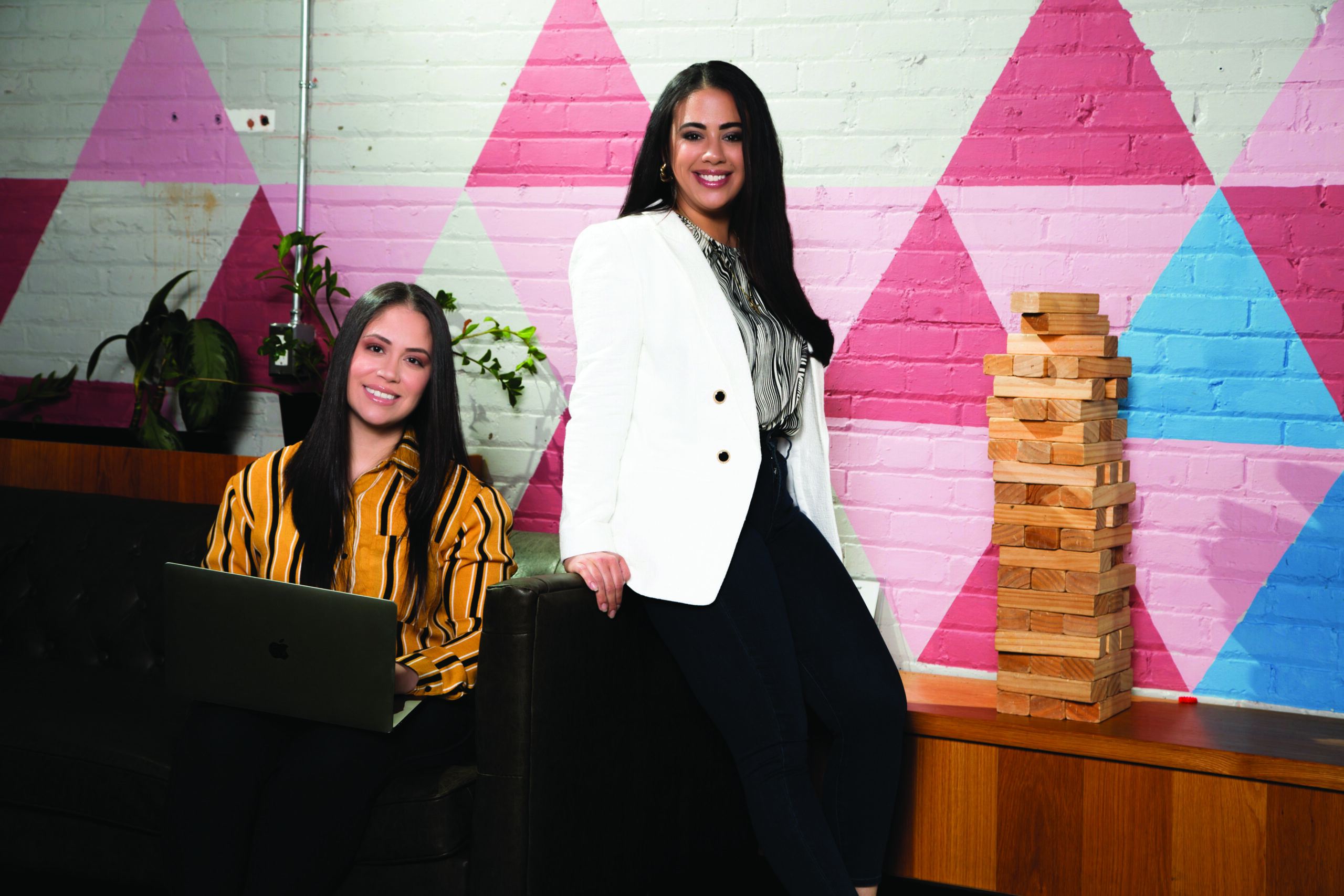 Ashley and Sabrina sitting by desk in office